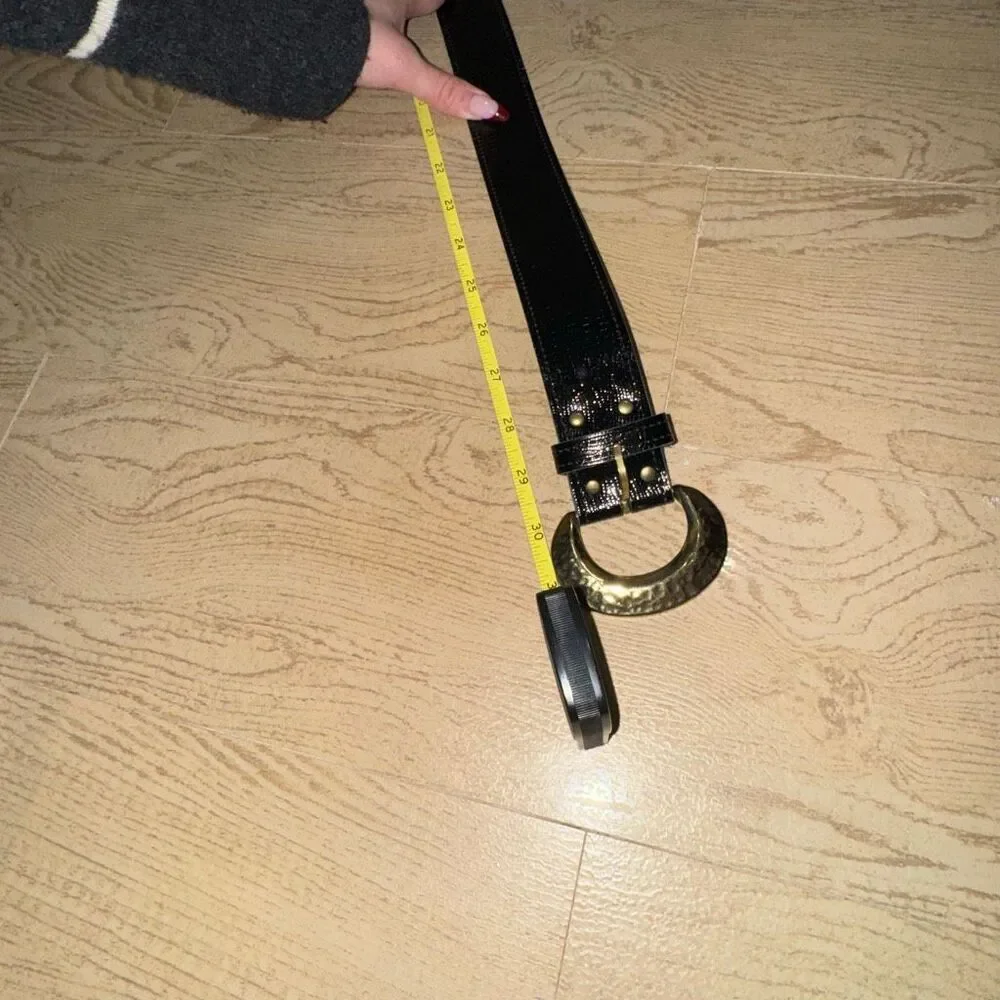 black patent leather belt with a large gold buckle, possibly a vintage 80's styl
